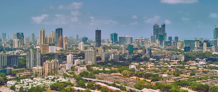 The Mumbai skyline under a pale blue sky