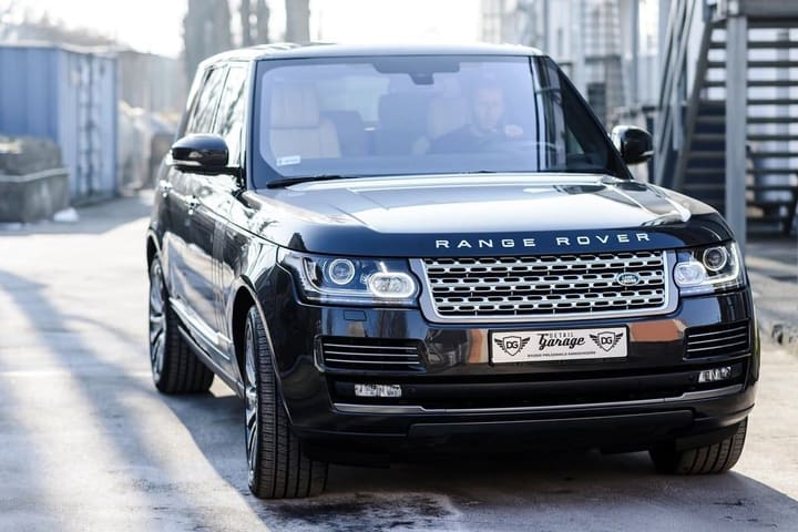 A dark Range Rover photographed from the front